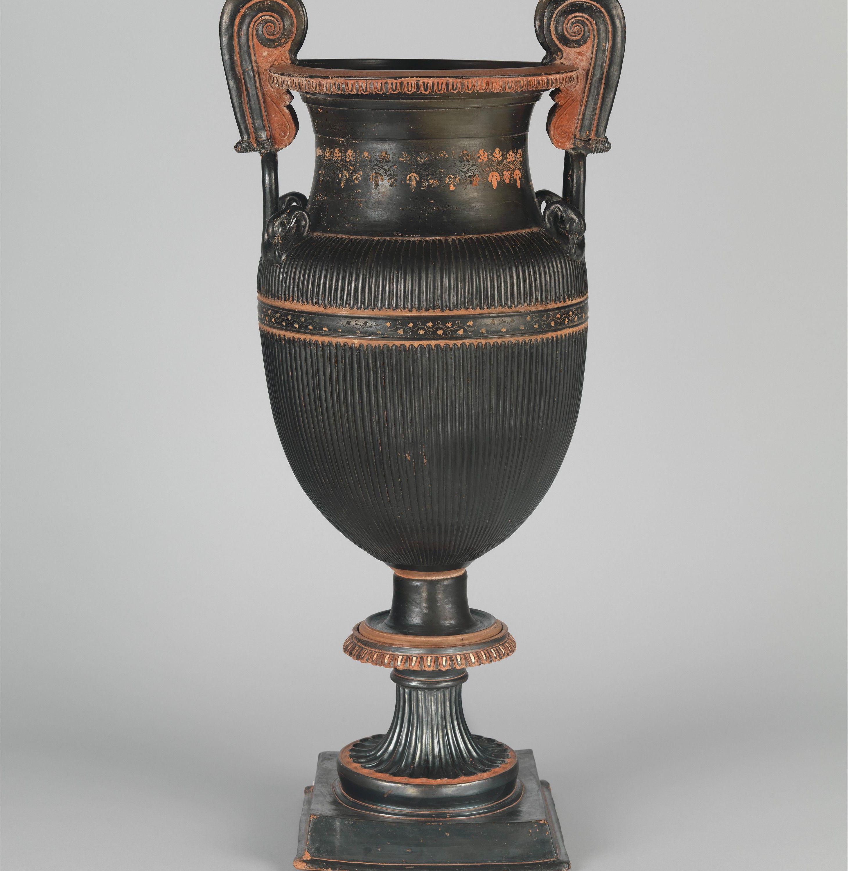 Pair of terracotta volute-kraters (vases for mixing wine and water) with stands