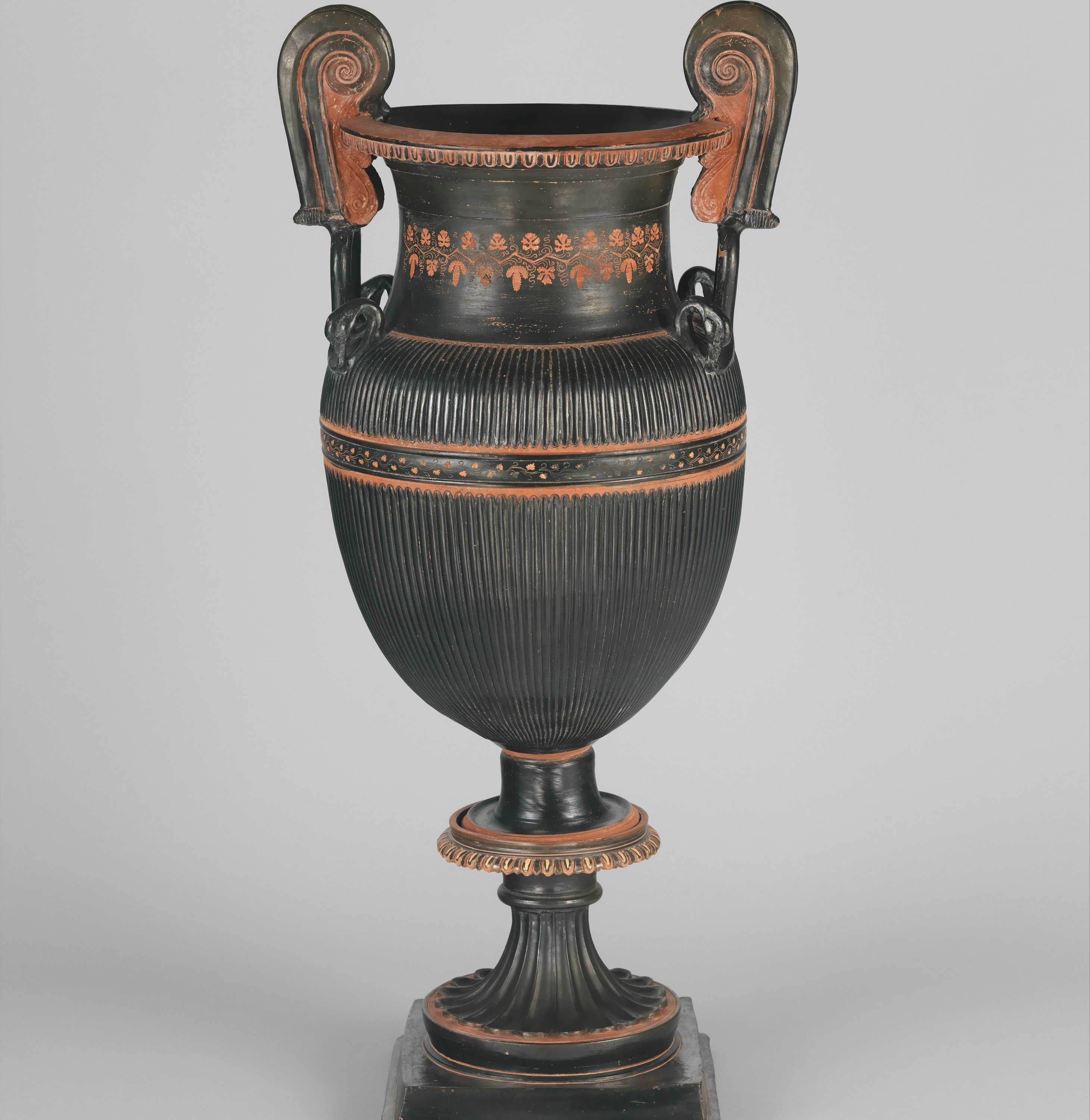 Pair of terracotta volute-kraters (vases for mixing wine and water) with stands