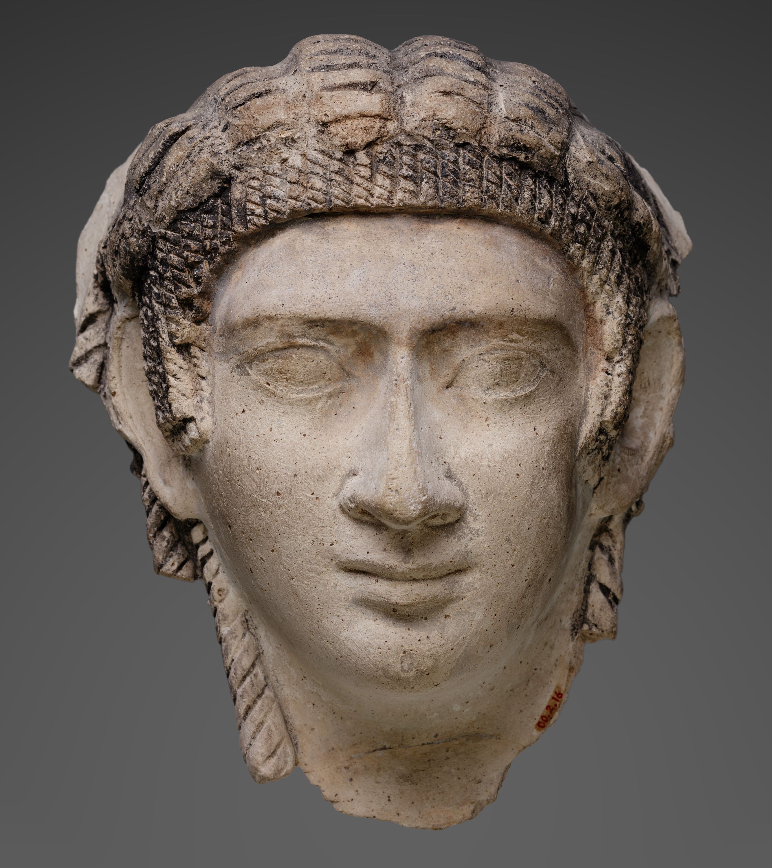 Mask of a woman with corkscrew locks and bangs