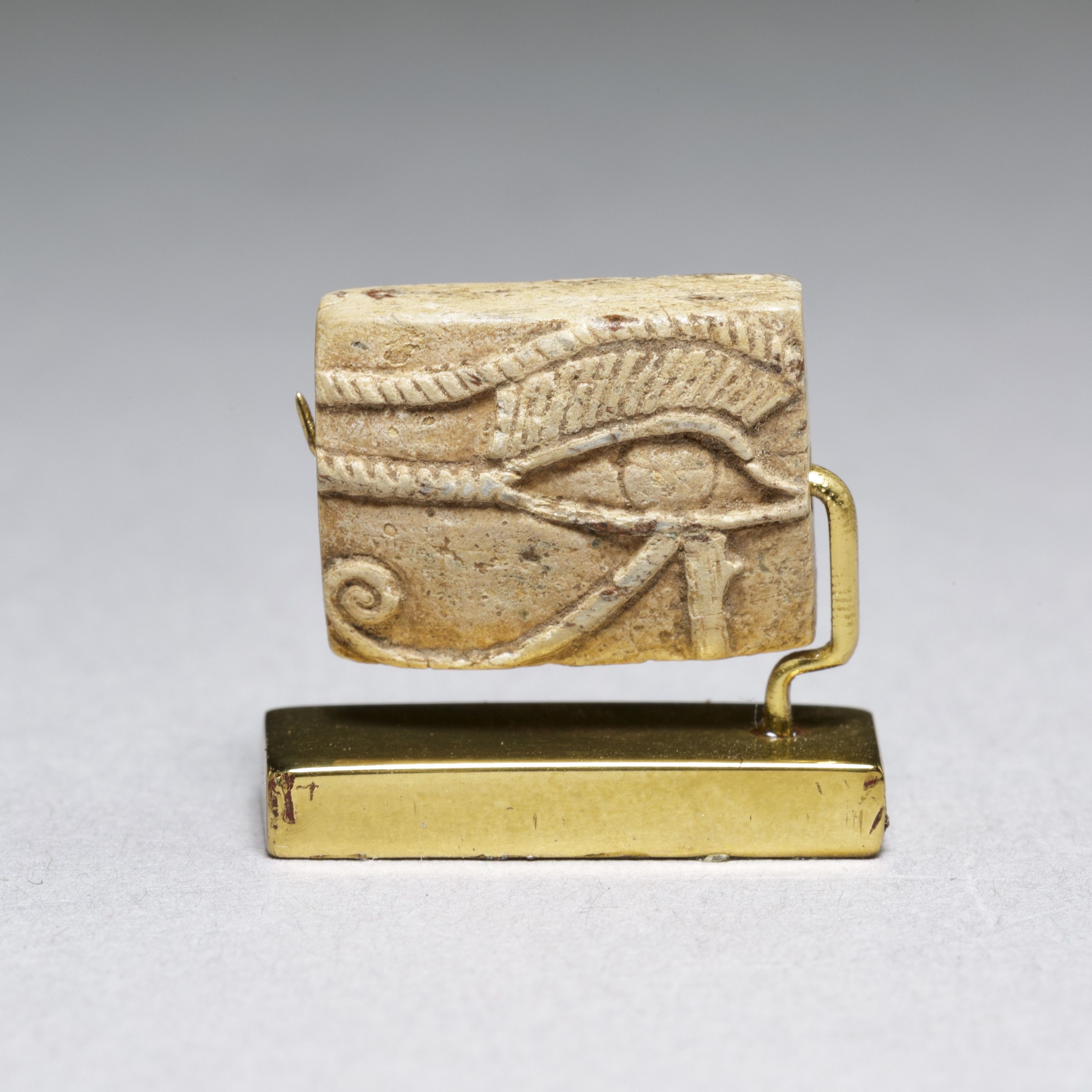 Wedjat Plaque; on opposite side Maat, Re, Upper and Lower Egyptian serpents over nub sign