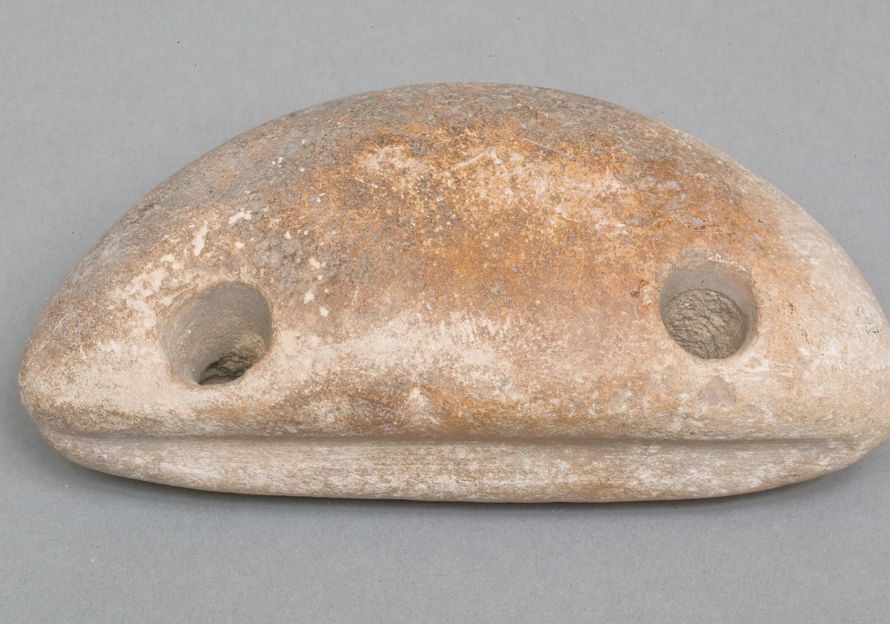 Weighing down device (fish net sinker?)