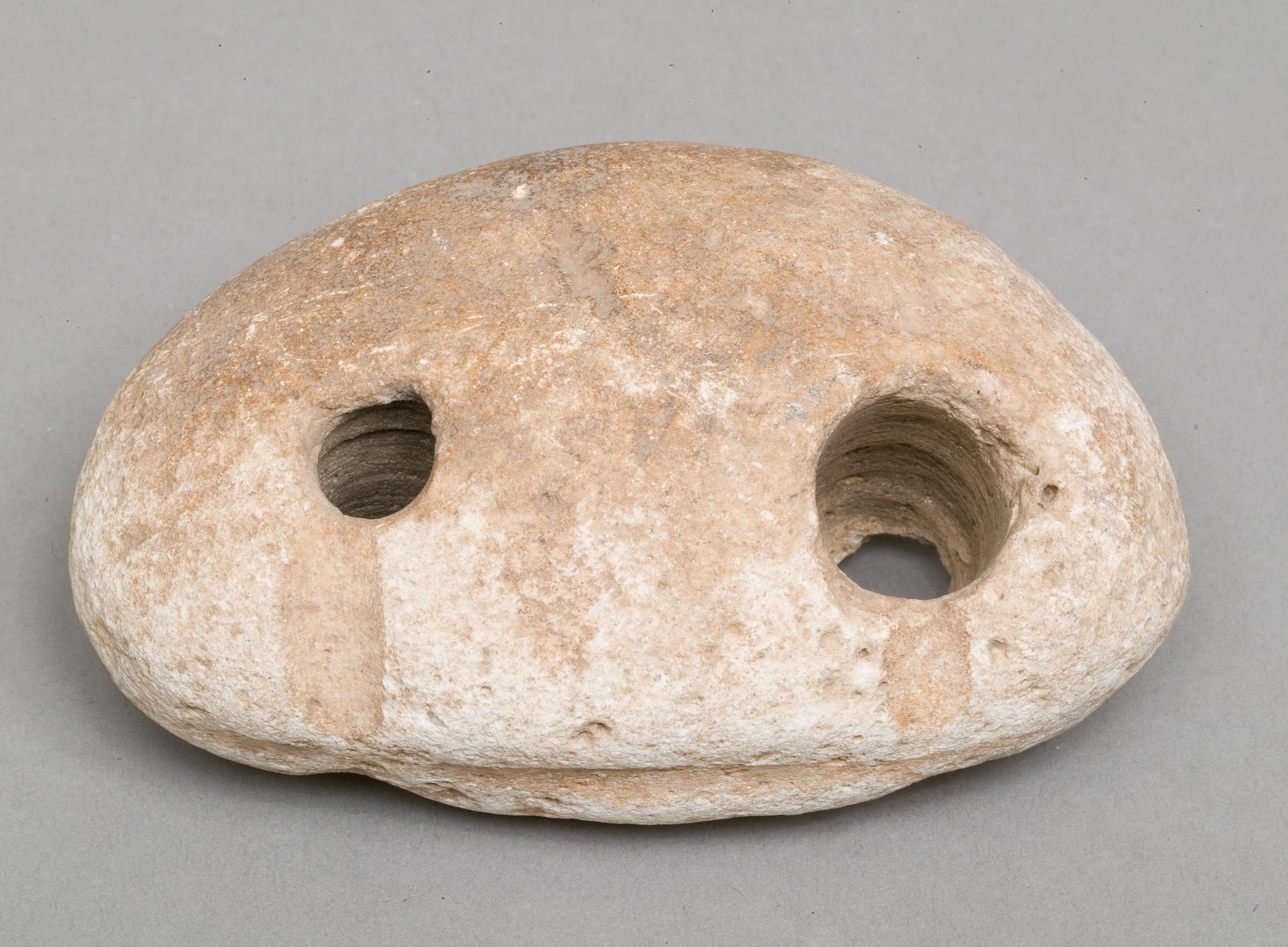 Weighing down device (fish net sinker?)