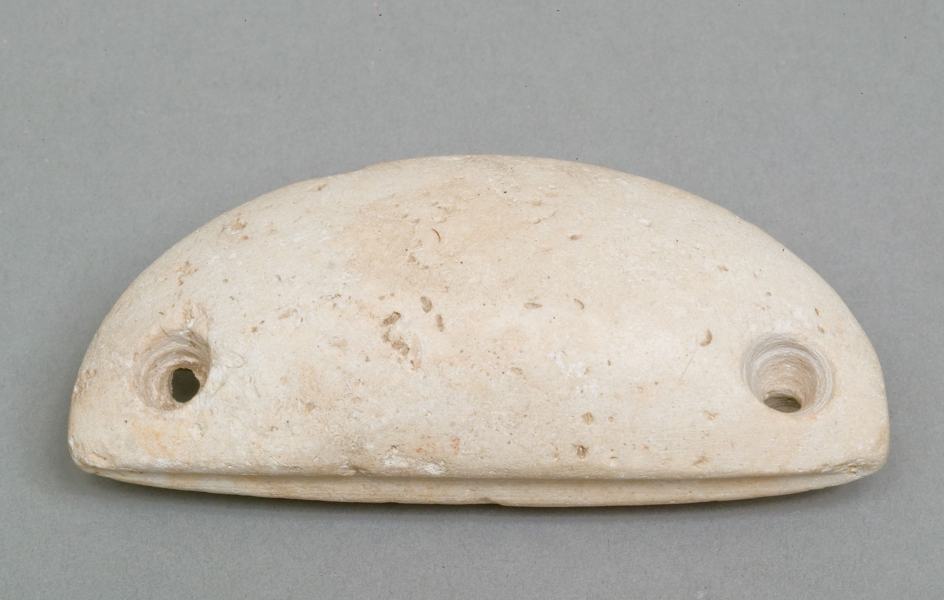 Weighing down device (fish net sinker?)