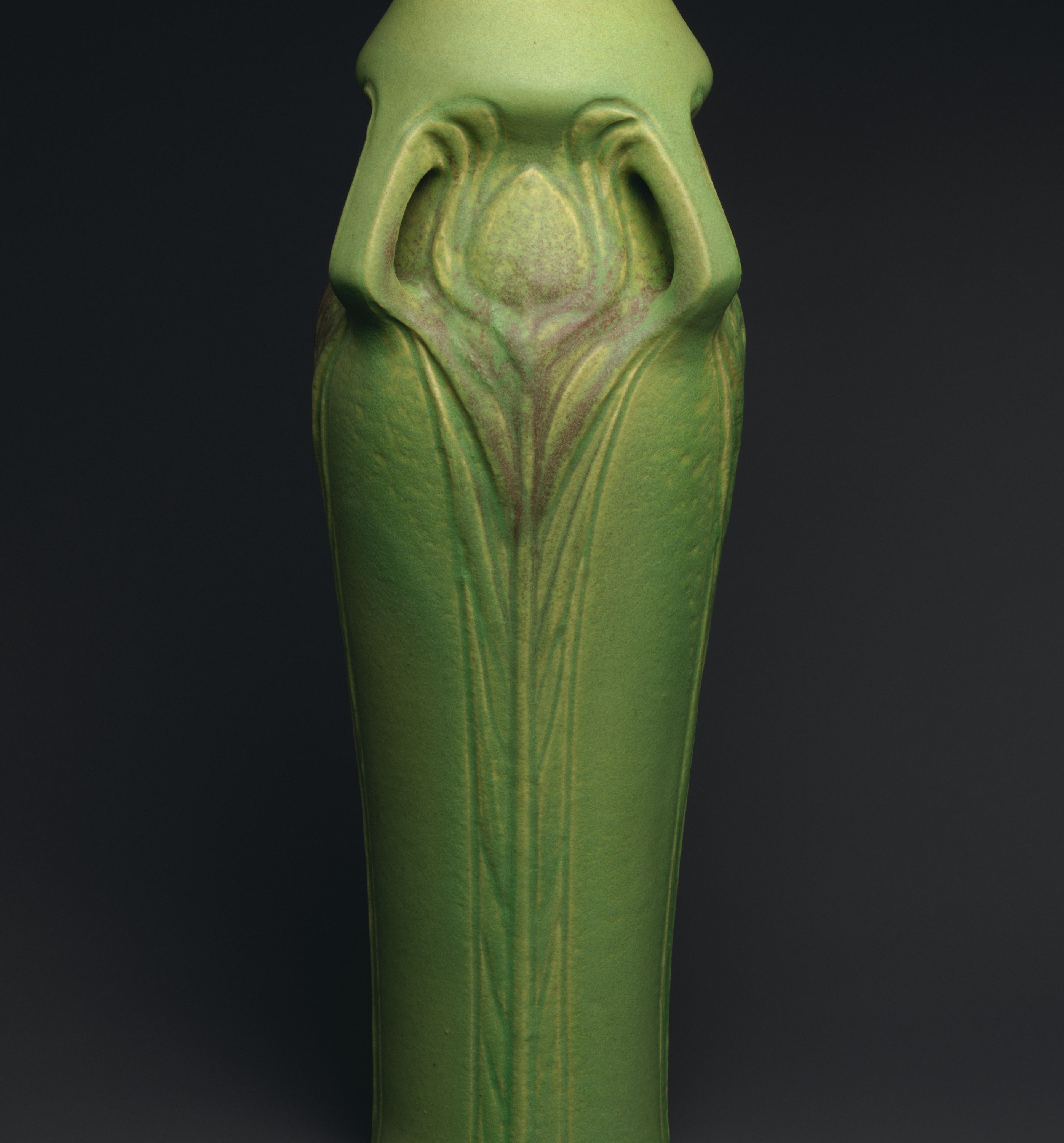 Vase with peacock feathers by Artus Van Briggle