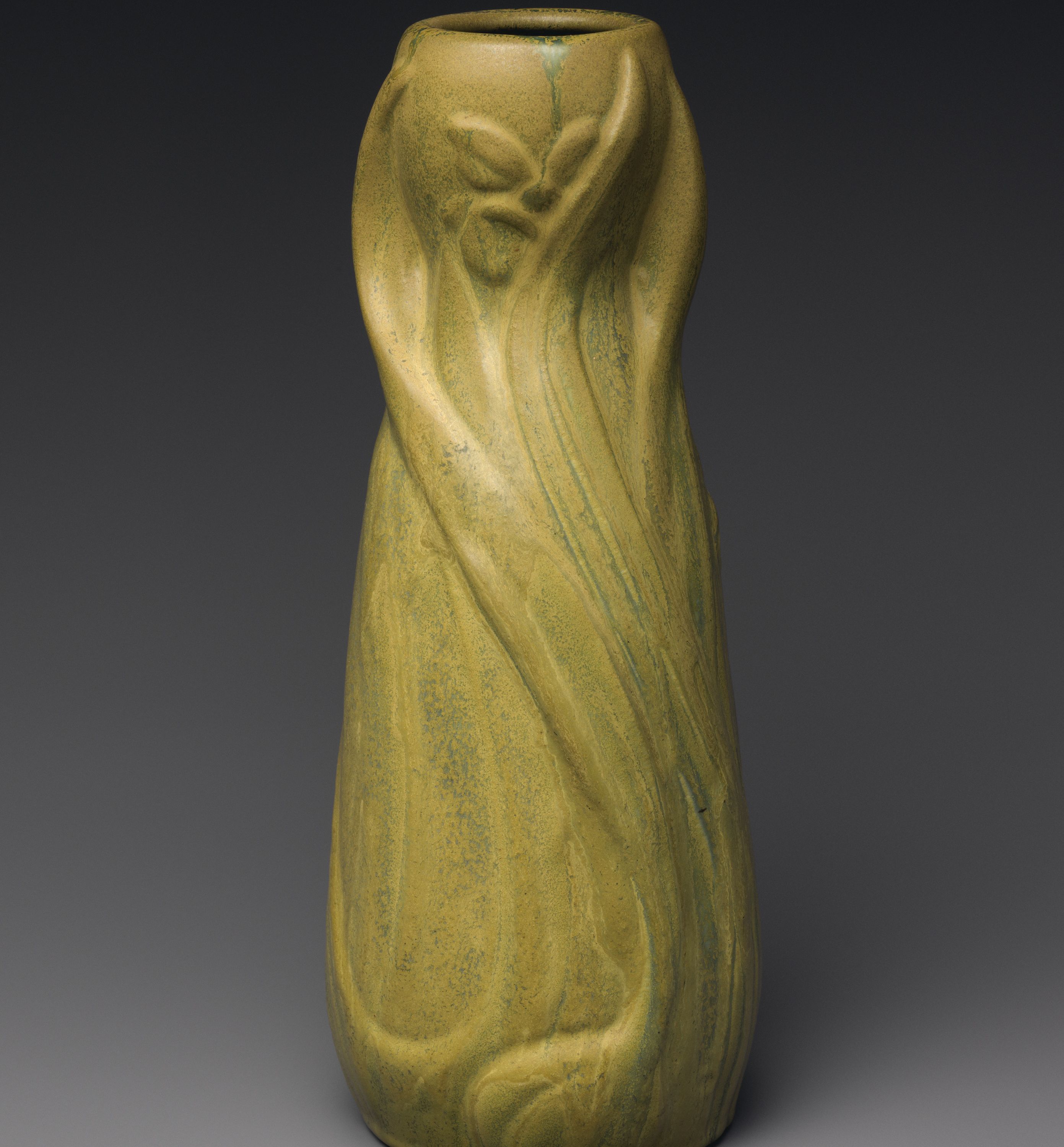 Vase with daffodils by Artus Van Briggle